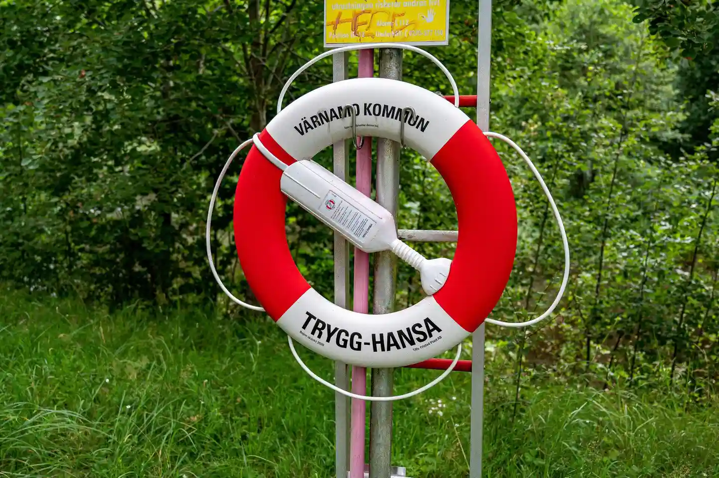 En livboj upphängd på en stolpe vid vattnet på Värnamo Camping.