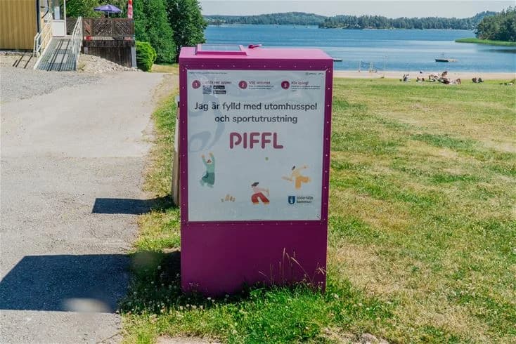 Bild av en reklamskylt för Farstanäs Camping & Havsbad, med informationsgrafik och text som marknadsför platsens faciliteter och aktiviteter. Skylten är designad för att locka besökare och innehåller detaljer om campingens läge och erbjudanden.