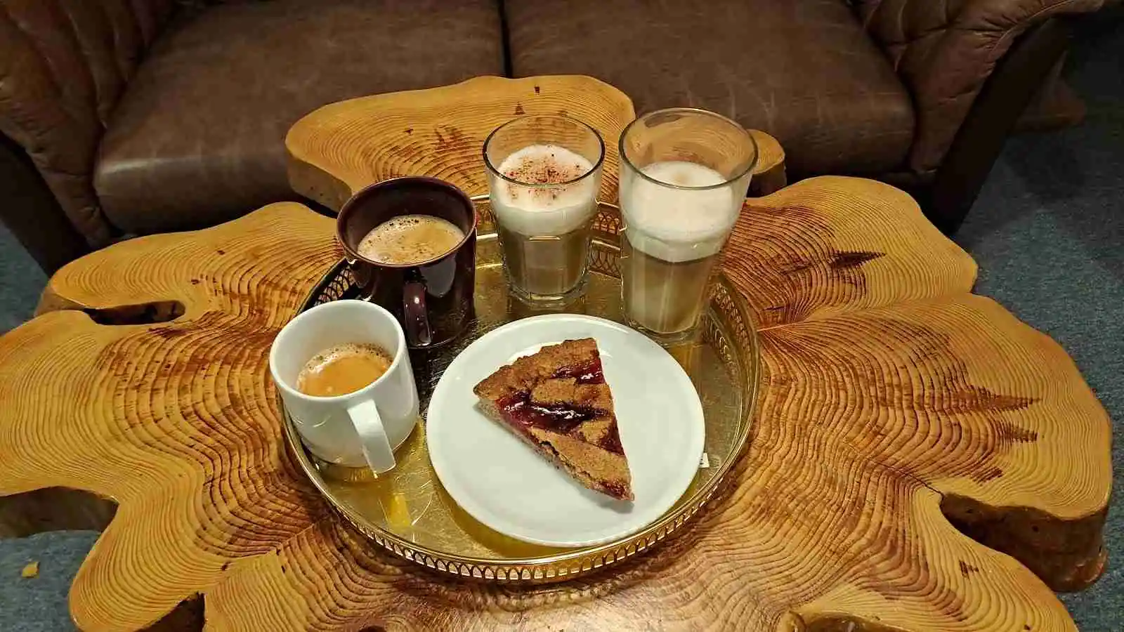 En välkomnande matsal med ett dukat träbord, där tallrikar, glas och koppar är framställda. Rummet har en hemtrevlig atmosfär och man kan se kaffe och kanske en lätt måltid serverad.