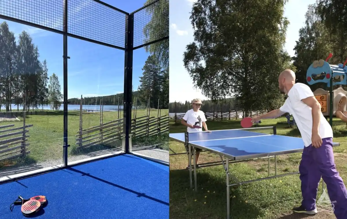 En utomhusbana för bordtennis under skuggan av träd vid Bjursås Berg & Sjö, där människor njuter av utomhusaktiviteter.